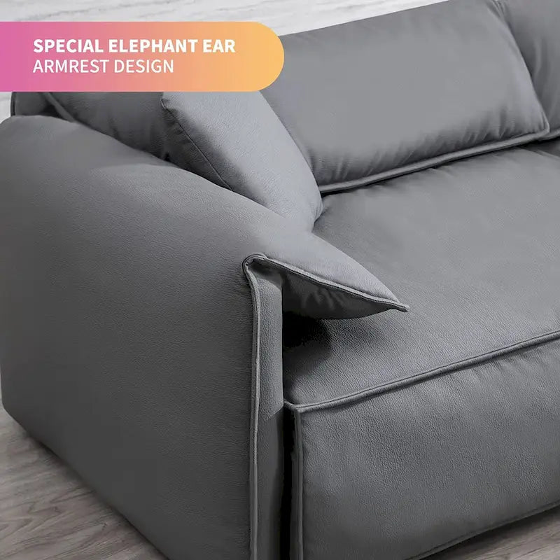 Canapé Mixoy 4 places à assise profonde et rembourrée, style italien minimaliste, 97 cm, avec accoudoirs en forme d'oreilles d'éléphant et coussin décoratif.