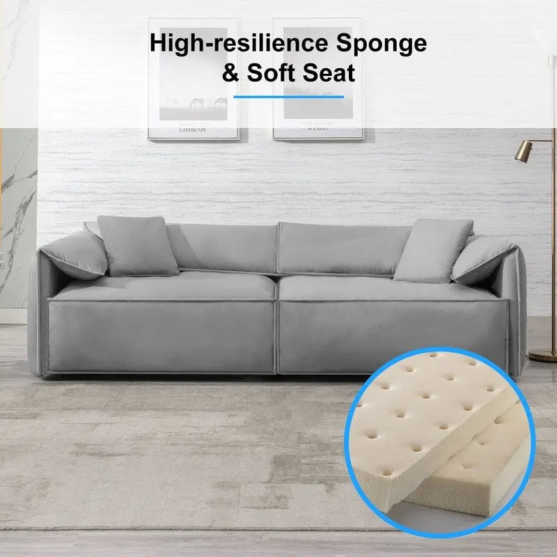 Canapé Mixoy 4 places à assise profonde et rembourrée, style italien minimaliste, 97 cm, avec accoudoirs en forme d'oreilles d'éléphant et coussin décoratif.