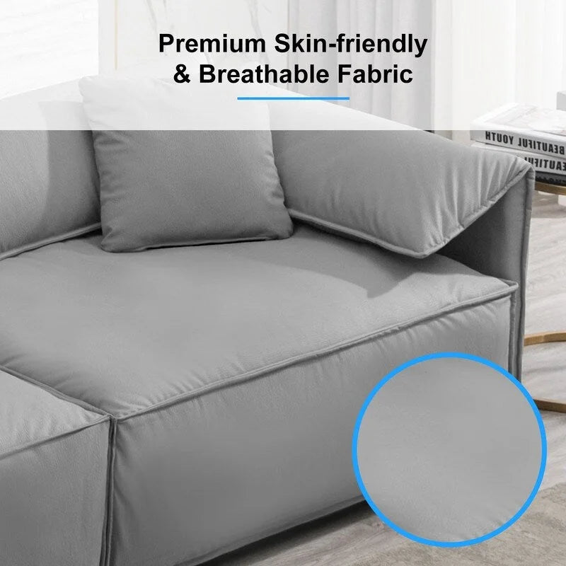 Canapé Mixoy 4 places à assise profonde et rembourrée, style italien minimaliste, 97 cm, avec accoudoirs en forme d'oreilles d'éléphant et coussin décoratif.