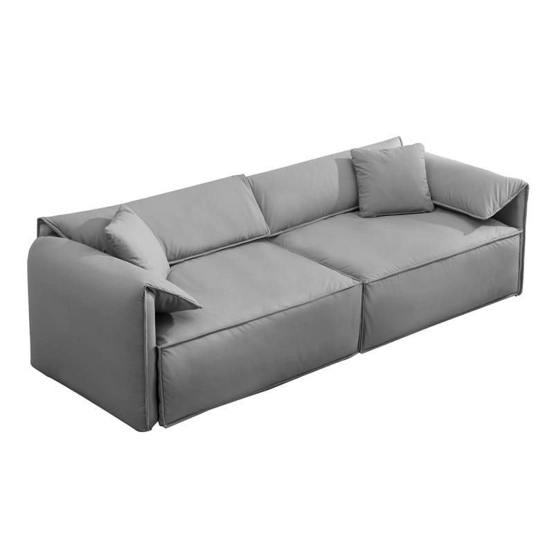 Canapé Mixoy 4 places à assise profonde et rembourrée, style italien minimaliste, 97 cm, avec accoudoirs en forme d'oreilles d'éléphant et coussin décoratif.