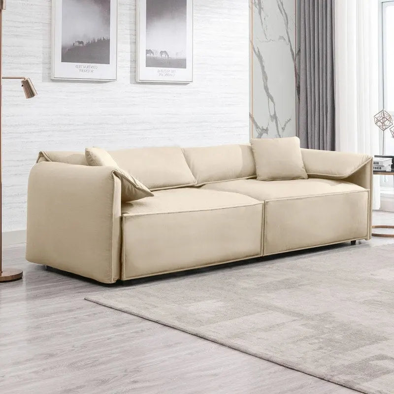 Canapé Mixoy 4 places à assise profonde et rembourrée, style italien minimaliste, 97 cm, avec accoudoirs en forme d'oreilles d'éléphant et coussin décoratif.