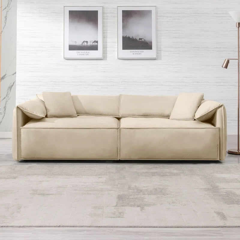 Canapé Mixoy 4 places à assise profonde et rembourrée, style italien minimaliste, 97 cm, avec accoudoirs en forme d'oreilles d'éléphant et coussin décoratif.