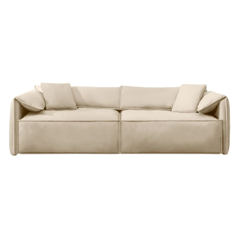 Canapé Mixoy 4 places à assise profonde et rembourrée, style italien minimaliste, 97 cm, avec accoudoirs en forme d'oreilles d'éléphant et coussin décoratif.