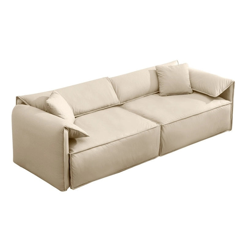 Canapé Mixoy 4 places à assise profonde et rembourrée, style italien minimaliste, 97 cm, avec accoudoirs en forme d'oreilles d'éléphant et coussin décoratif.