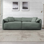 Canapé Mixoy 4 places à assise profonde et rembourrée, style italien minimaliste, 97 cm, avec accoudoirs en forme d'oreilles d'éléphant et coussin décoratif.